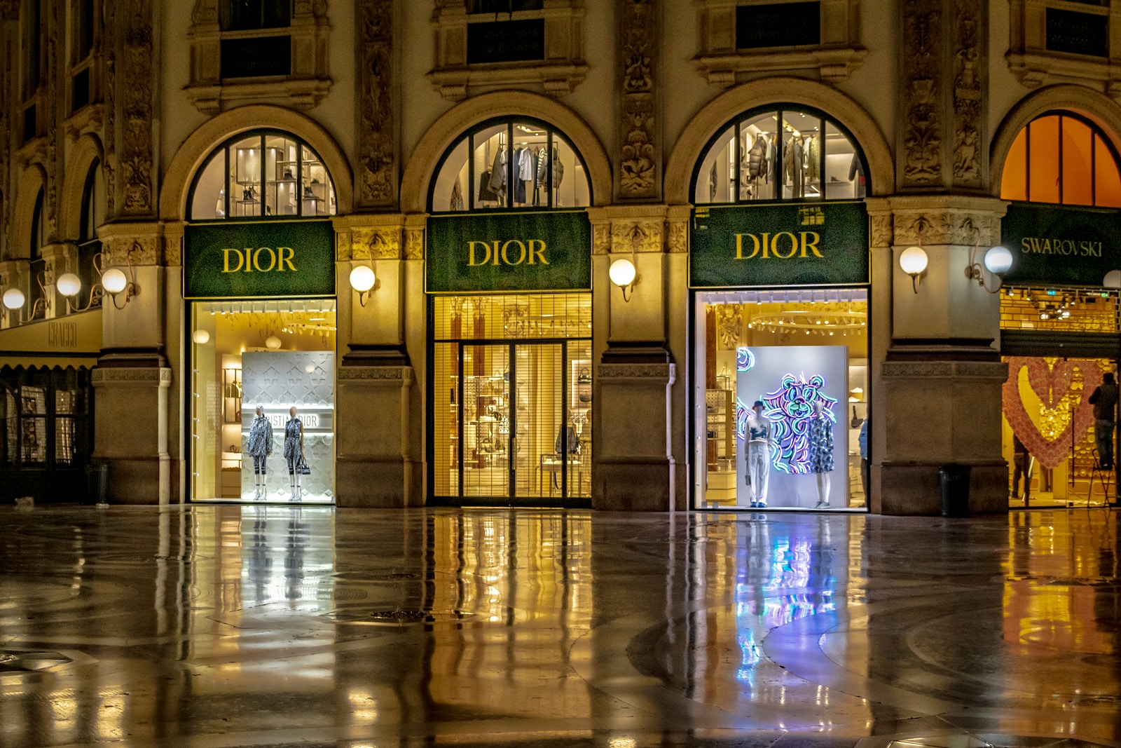 a large building with a few people walking through it